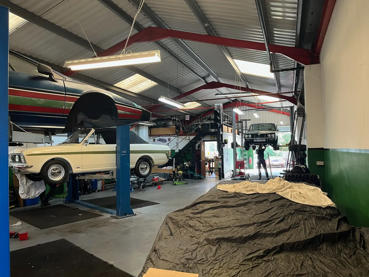 Busy workshop with multiple specialist cars at Goblin Automotive